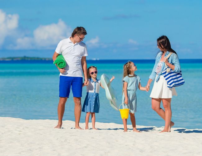 Young family of four on beach vacation